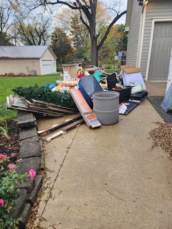 Dumpster being loaded with debris for Residential Dumpster Rental in Pine Manor